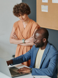 Woman and man are looking at the laptop